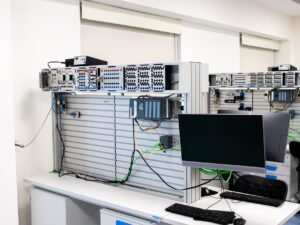 A contemporary office showcasing a server rack and computer workspace, ideal for tech and business settings.