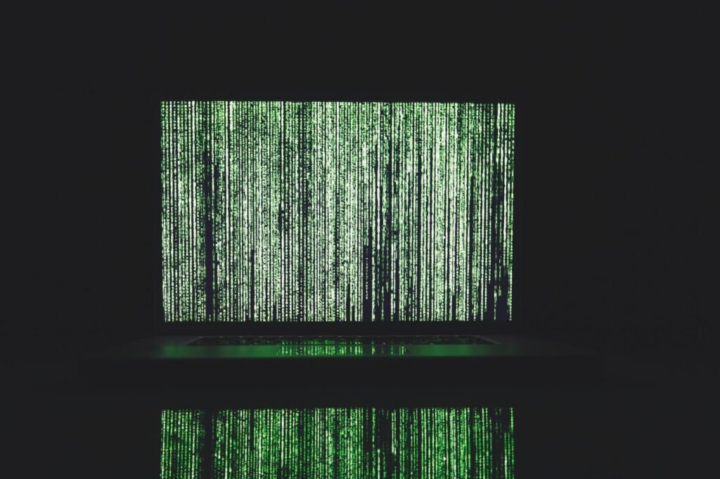 Abstract depiction of green matrix code on a computer monitor.